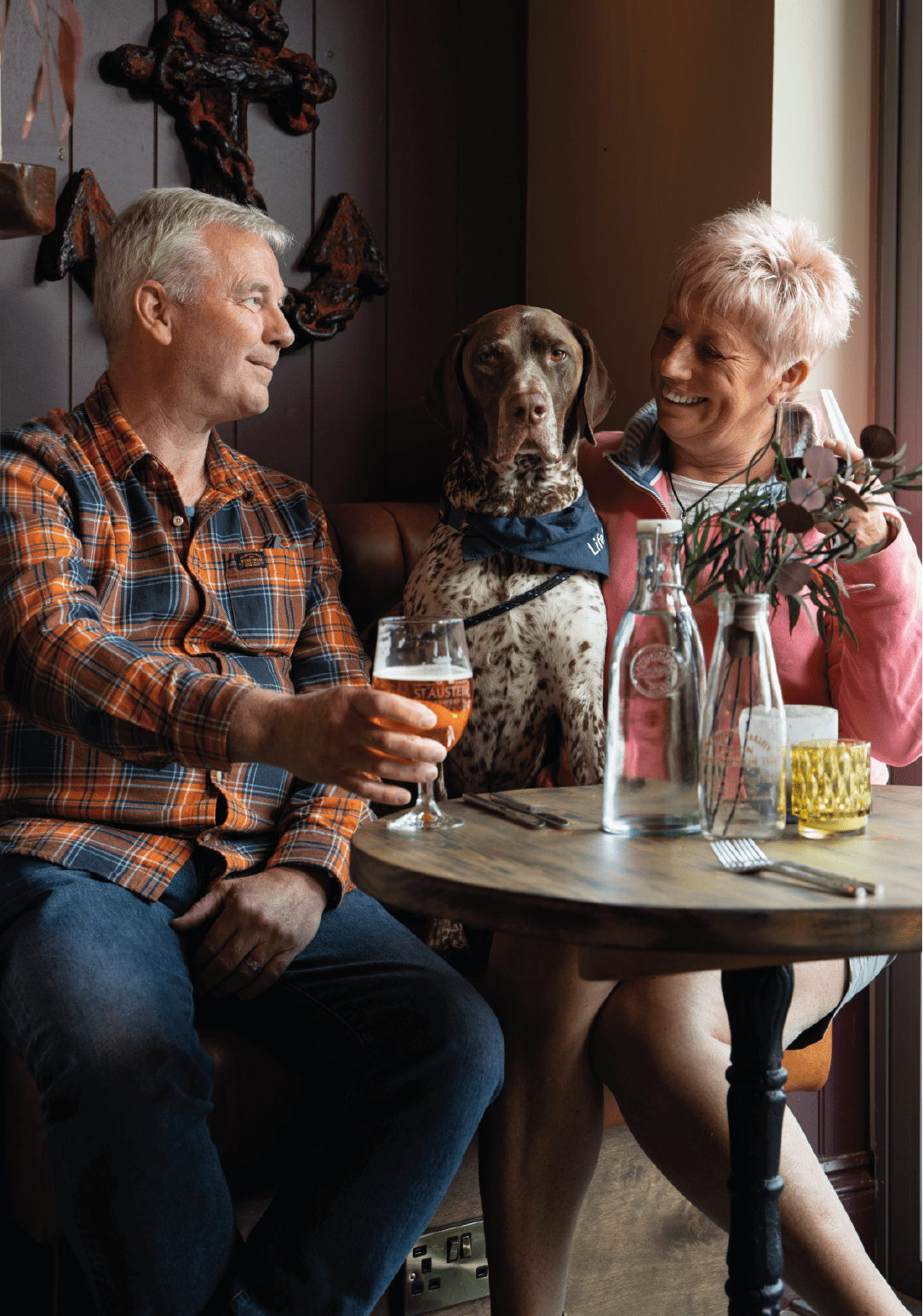 Couple in pub with dog.