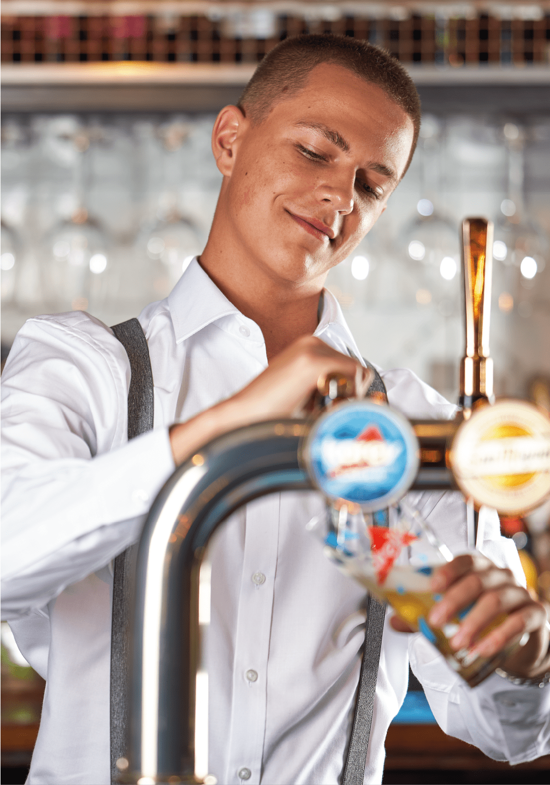 Employee pouring a pint. 